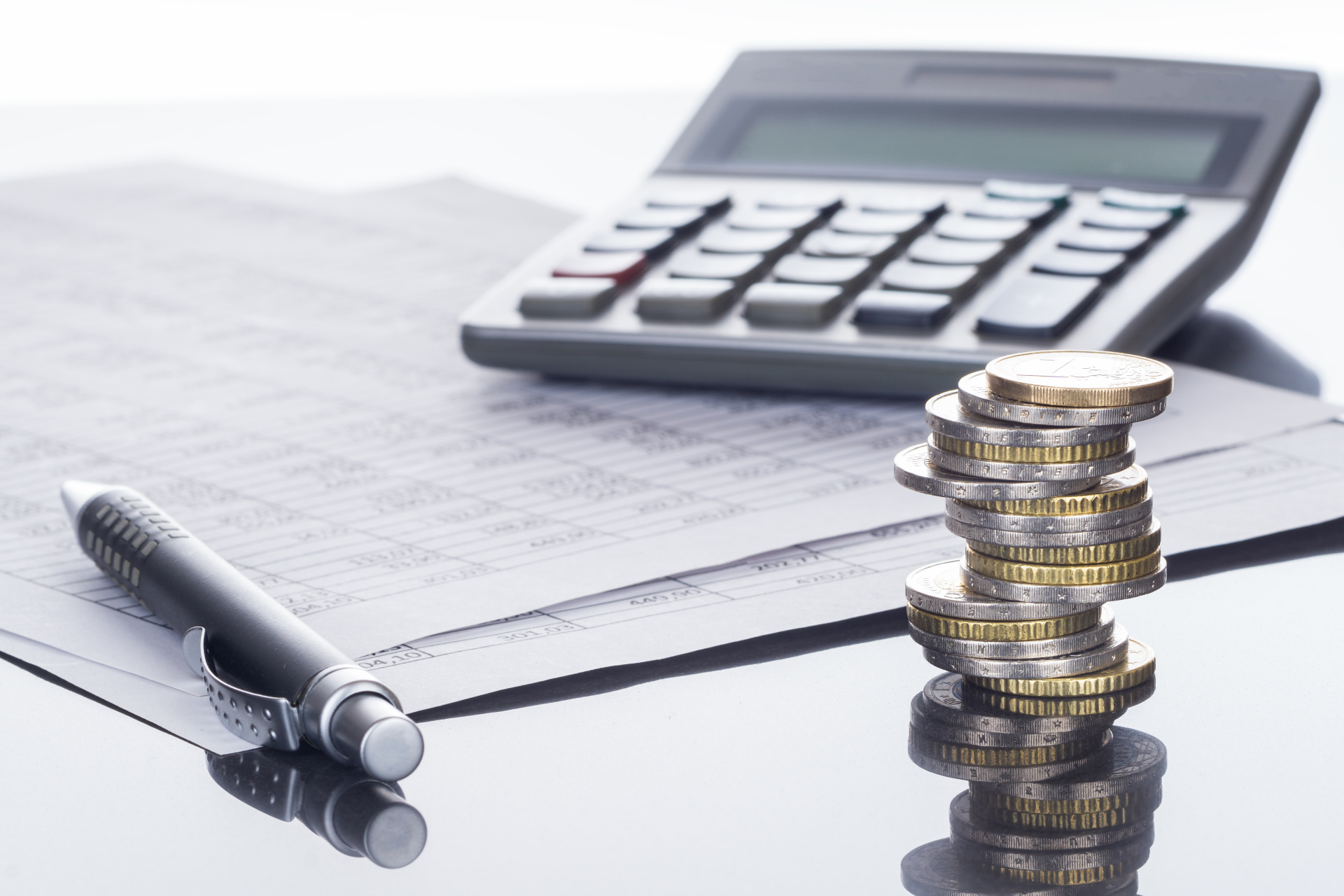 Finanzen, Euro Münzstapel, Kugelschreiber, Tabellen, und Taschenrechner, Hintergrund