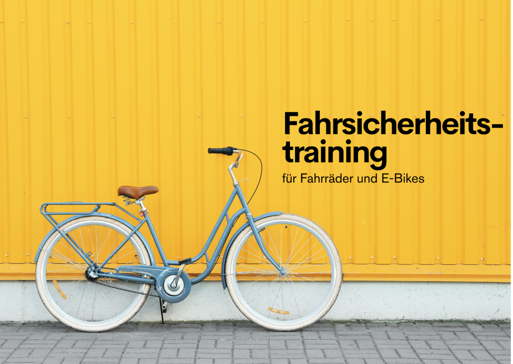 Blaues Fahrrad vor gelber Wand.